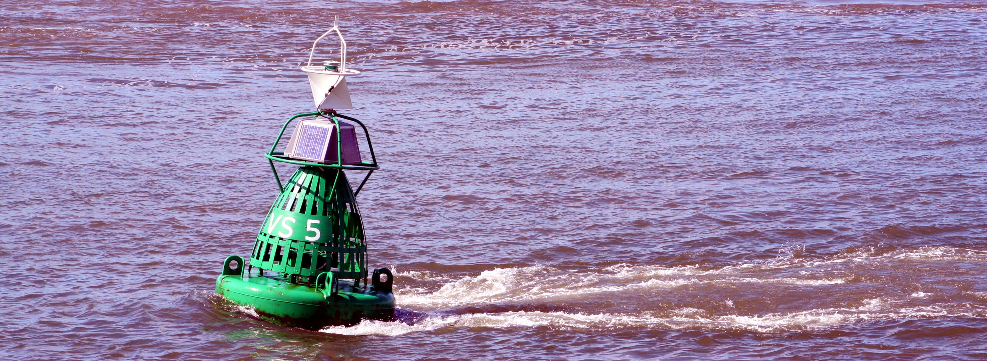 Tethered buoy in a tidal stream showing the bulge in front and the flat surface behind.