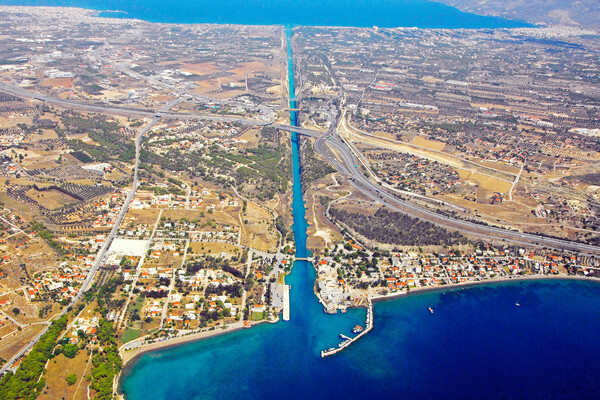 Aerial overview of the canal with the Saronic Gulf below and the Gulf of Corinth in the distance.